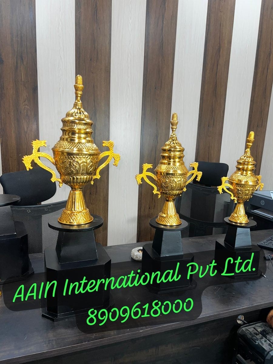 Rajni Cups in three heights, all in gold, with tiered lids and sculpted handles